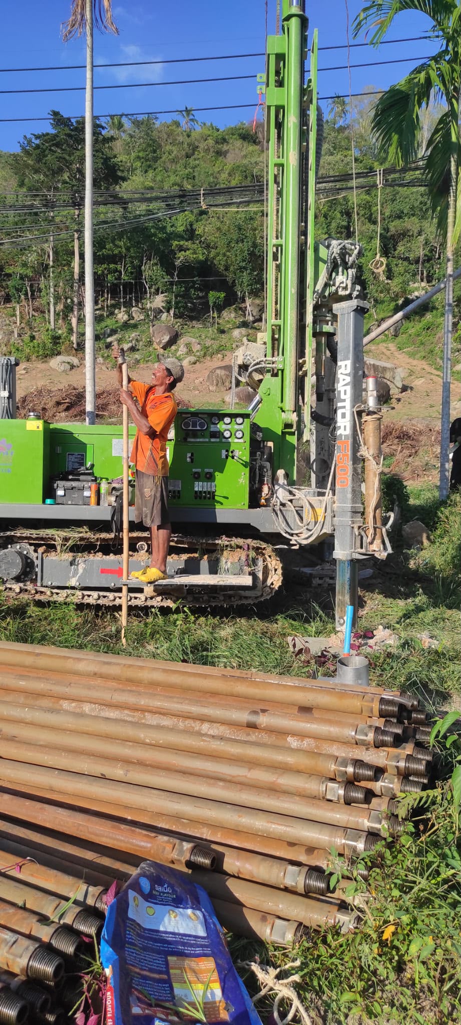 Construction crew handling drill rods at ULU Villas Samui