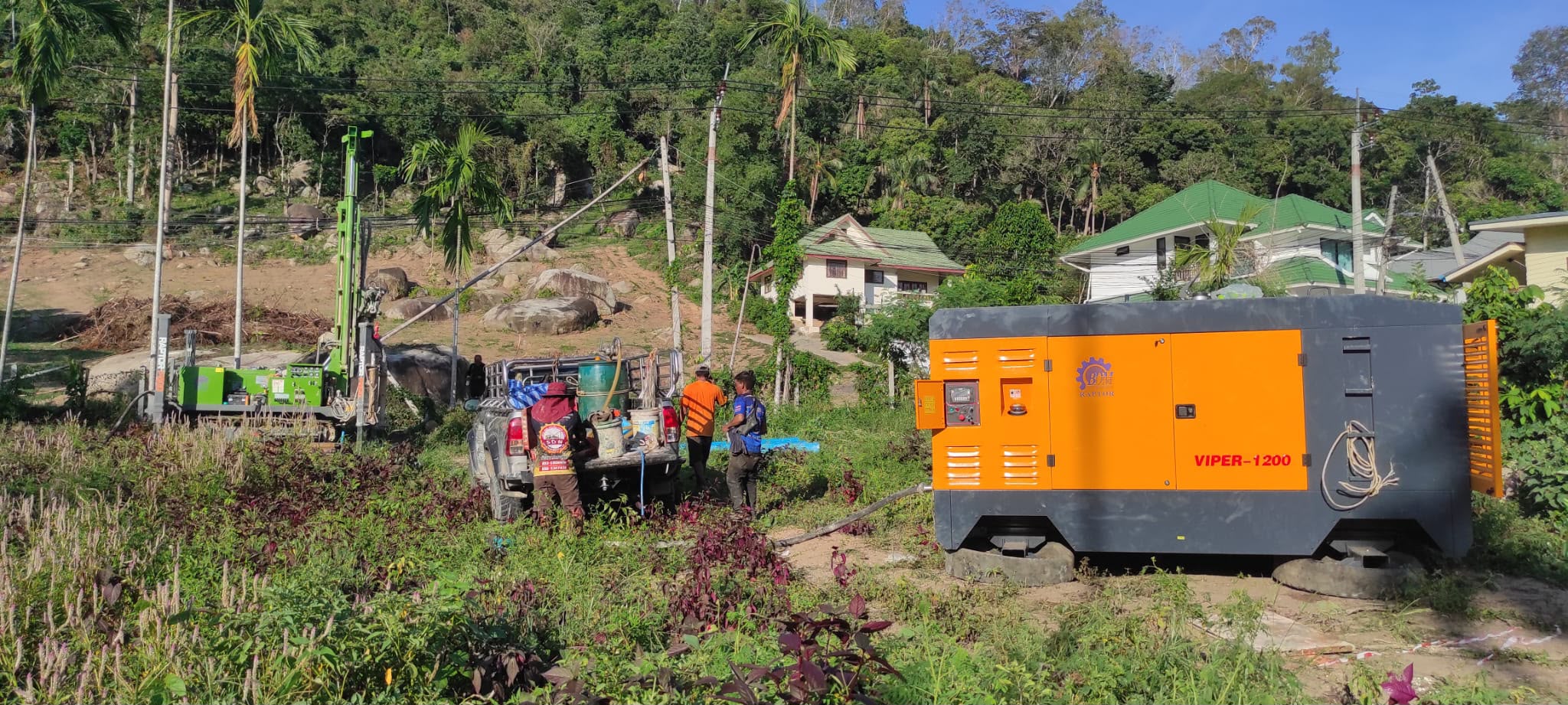 Air compressor and crew clearing granite rocks at ULU Villas Samui